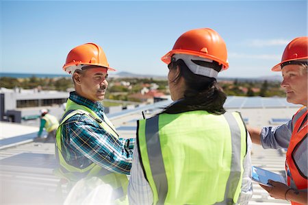 simsearch:6108-06168107,k - Workers talking at solar power plant Stock Photo - Premium Royalty-Free, Code: 6113-09157776