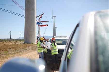 Engineers reviewing blueprints at wind turbine power plant Stock Photo - Premium Royalty-Free, Code: 6113-09157782