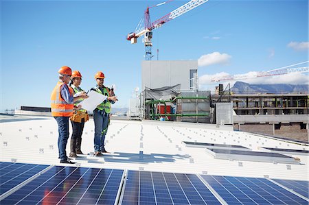 simsearch:6108-06168107,k - Engineers with blueprint at solar panels at sunny power plant Stock Photo - Premium Royalty-Free, Code: 6113-09157805