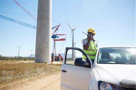 environmental engineer - Engineer using walkie-talkie at truck at sunny wind turbine power plant Stock Photo - Premium Royalty-Free, Code: 6113-09157806