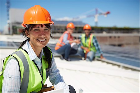 simsearch:6108-06168107,k - Portrait smiling, confident female engineer at sunny power plant Stock Photo - Premium Royalty-Free, Code: 6113-09157814