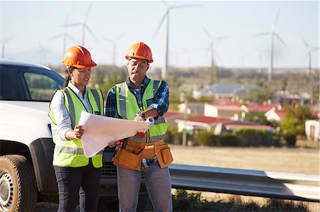 simsearch:6108-06168107,k - Engineers reviewing blueprints near wind turbine farm Stock Photo - Premium Royalty-Free, Code: 6113-09157838