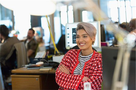 Smiling, confident creative businesswoman working in office Stock Photo - Premium Royalty-Free, Code: 6113-09159948