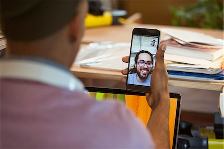 skype - Businessman video chatting with colleague on smart phone Stock Photo - Premium Royalty-Free, Code: 6113-09159910