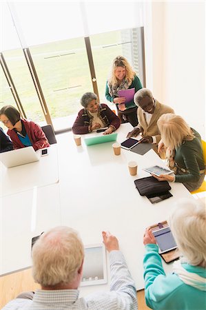 simsearch:6113-06720636,k - Senior business people using digital tablets and laptops in conference room meeting Stock Photo - Premium Royalty-Free, Code: 6113-09160284
