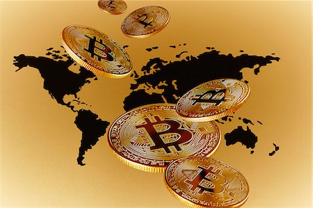 simsearch:700-05452103,k - Golden Bitcoins over global map Stock Photo - Premium Royalty-Free, Code: 6113-09160203