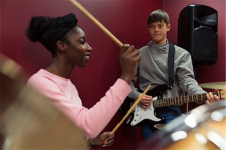 simsearch:649-07063808,k - Teenage musicians recording music, playing guitar and drums in sound booth Stock Photo - Premium Royalty-Free, Code: 6113-09168264