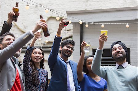 simsearch:6113-06909171,k - Friends toasting drinks at party on patio Stock Photo - Premium Royalty-Free, Code: 6113-09168584