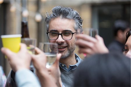 simsearch:6113-06909171,k - Happy man toasting drinks with friends at party Stock Photo - Premium Royalty-Free, Code: 6113-09168594