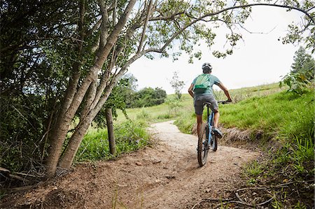 simsearch:6113-08321095,k - Man mountain biking on rural trail Stock Photo - Premium Royalty-Free, Code: 6113-09168860