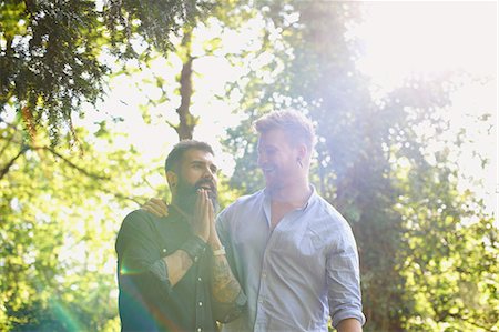 simsearch:614-08148673,k - Affectionate male gay couple in sunny park Stock Photo - Premium Royalty-Free, Code: 6113-09168890