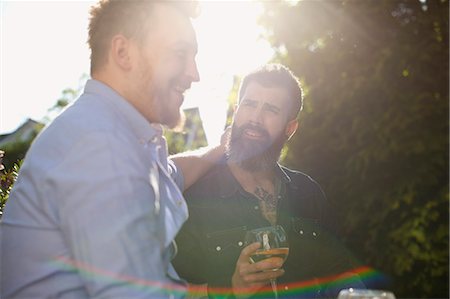simsearch:614-08148673,k - Affectionate male gay couple drinking wine in sunny garden Stock Photo - Premium Royalty-Free, Code: 6113-09168897