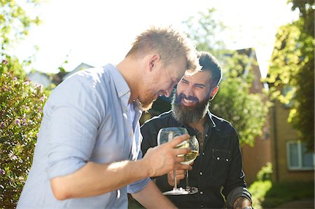 simsearch:614-08148673,k - Happy male gay couple drinking wine in sunny garden Stock Photo - Premium Royalty-Free, Code: 6113-09168900