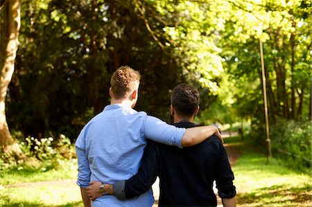 simsearch:614-08148673,k - Affectionate male gay couple hugging, walking in sunny park Stock Photo - Premium Royalty-Free, Code: 6113-09168902