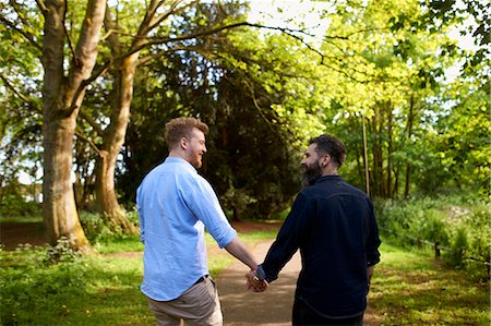 simsearch:614-08148673,k - Affectionate male gay couple holding hands in sunny park Stock Photo - Premium Royalty-Free, Code: 6113-09168904