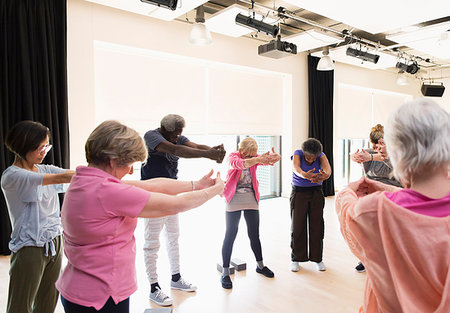 Active seniors exercising, stretching arms and back in circle Stock Photo - Premium Royalty-Free, Code: 6113-09178658