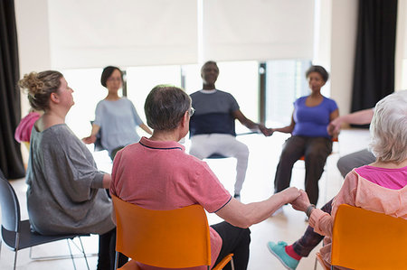 stage chairs - Serene active seniors holding hands, meditating in circle Stock Photo - Premium Royalty-Free, Code: 6113-09178636