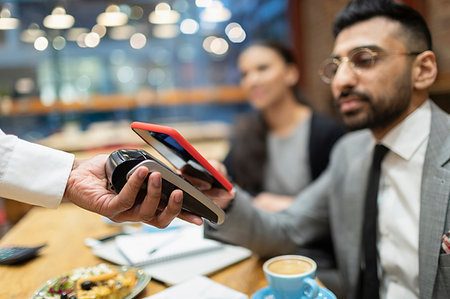 simsearch:6108-06907863,k - Businessman in cafe paying with smart phone contactless payment Stock Photo - Premium Royalty-Free, Code: 6113-09178783