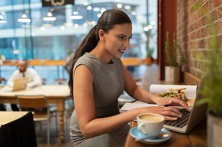 simsearch:6113-07730780,k - Businesswoman working at laptop in cafe Stock Photo - Premium Royalty-Free, Code: 6113-09178804