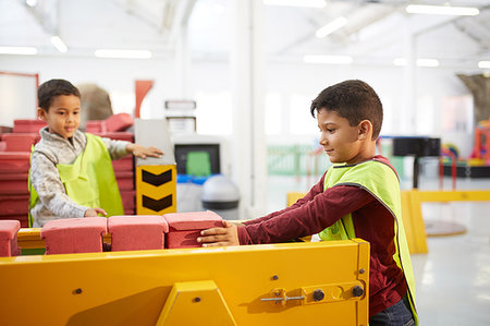 Boy playing at interactive construction exhibit in science center Stock Photo - Premium Royalty-Free, Code: 6113-09178901