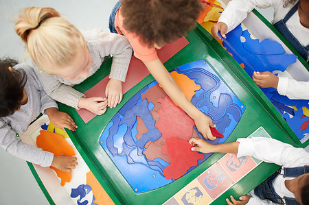 school head girl - View from above kids playing at interactive exhibit in science center Stock Photo - Premium Royalty-Free, Code: 6113-09178905