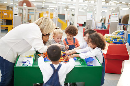 Teacher and students playing at interactive exhibit in science center Stock Photo - Premium Royalty-Free, Code: 6113-09178909