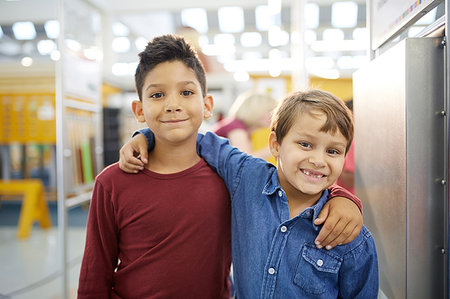 Portrait cute boys hugging in science center Stock Photo - Premium Royalty-Free, Code: 6113-09178917