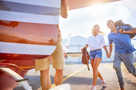 recreational pursuit - Happy, eager couple boarding small airplane Stock Photo - Premium Royalty-Free, Code: 6113-09179045