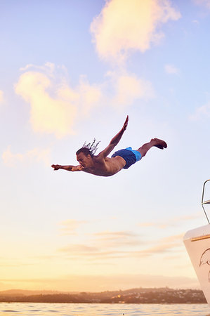 Young man diving into ocean Stock Photo - Premium Royalty-Free, Code: 6113-09179013