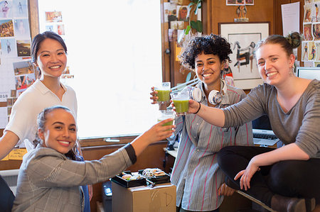 simsearch:6108-07969525,k - Portrait confident creative female designers drinking green smoothies in office Stock Photo - Premium Royalty-Free, Code: 6113-09179191