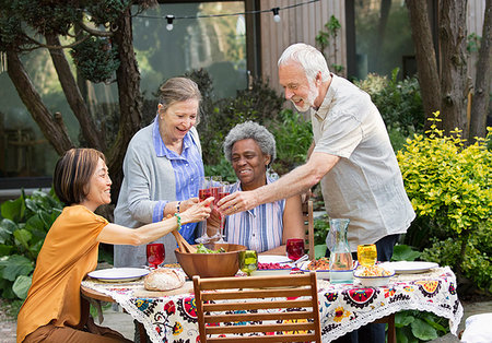 simsearch:6113-07242109,k - Active senior friends enjoying rose wine and lunch at patio table Stock Photo - Premium Royalty-Free, Code: 6113-09192008