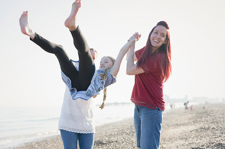 simsearch:649-07647801,k - Playful lesbian couple swinging daughter on beach Stock Photo - Premium Royalty-Free, Code: 6113-09199773