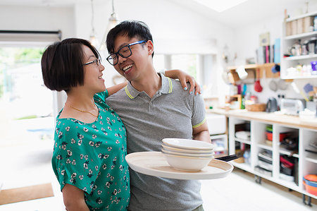 simsearch:6113-06720867,k - Affectionate couple hugging, doing dishes in kitchen Stock Photo - Premium Royalty-Free, Code: 6113-09199949