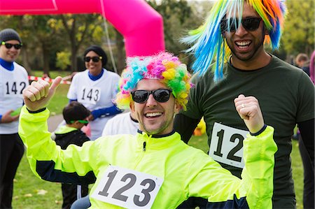 simsearch:6113-07148073,k - Portrait enthusiastic male runners wearing wigs at charity run Stock Photo - Premium Royalty-Free, Code: 6113-09131213