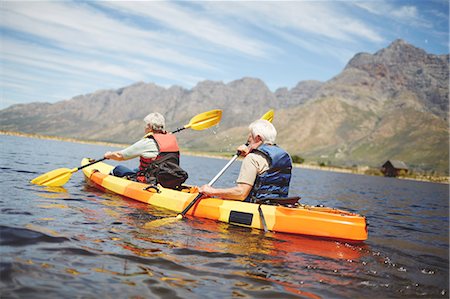 simsearch:6122-07699789,k - Active senior couple kayaking in sunny summer lake Stock Photo - Premium Royalty-Free, Code: 6113-09131474