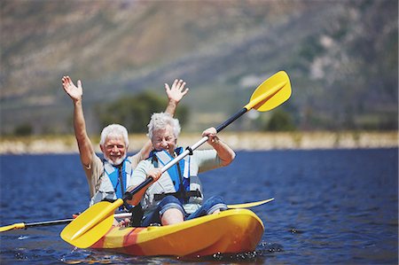 simsearch:6113-07589442,k - Playful, energetic active senior couple kayaking on sunny summer lake Stock Photo - Premium Royalty-Free, Code: 6113-09131485