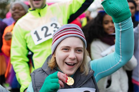 simsearch:6113-07648679,k - Enthusiastic woman with medal cheering at charity race Stock Photo - Premium Royalty-Free, Code: 6113-09131408