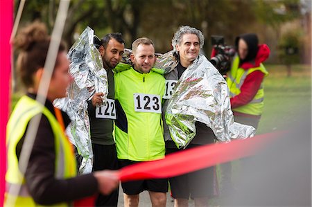 simsearch:6113-07730475,k - Male marathon runners wrapped in thermal blanket at finish line Stock Photo - Premium Royalty-Free, Code: 6113-09131413