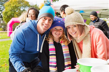 simsearch:6113-06720252,k - Portrait smiling, confident family at charity event in park Stock Photo - Premium Royalty-Free, Code: 6113-09131428