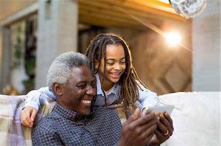 simsearch:6113-06908842,k - Grandfather and granddaughter using smart phone on sofa Stock Photo - Premium Royalty-Free, Code: 6113-09131580