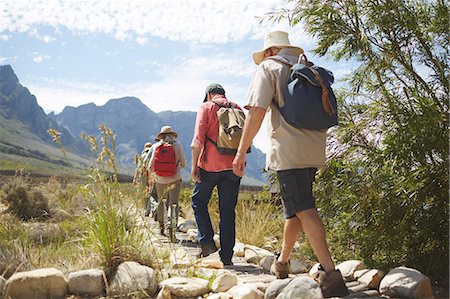 simsearch:693-06667816,k - Active senior friends with backpacks hiking along sunny summer footpath Stock Photo - Premium Royalty-Free, Code: 6113-09131516