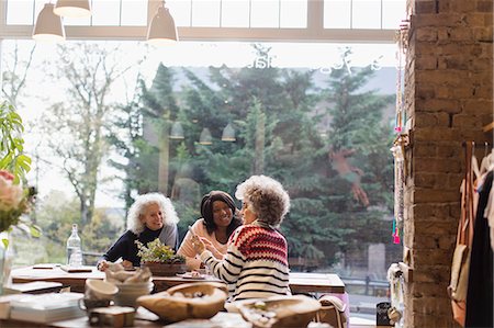 senior hispanic - Women friends with smart phone at cafe shop window Stock Photo - Premium Royalty-Free, Code: 6113-09131720