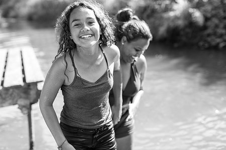 Portrait happy, carefree mother and daughter at river Photographie de stock - Premium Libres de Droits, Code: 6113-09240049