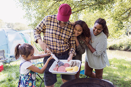 Excited family barbecuing at campsite Photographie de stock - Premium Libres de Droits, Code: 6113-09240014