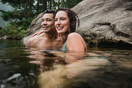 simsearch:6113-07147024,k - Affectionate young couple swimming in lake Stock Photo - Premium Royalty-Free, Code: 6113-09240145