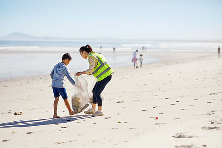 simsearch:859-06808649,k - Mother and son volunteers cleaning up litter on sunny, sandy beach Stock Photo - Premium Royalty-Free, Code: 6113-09240259