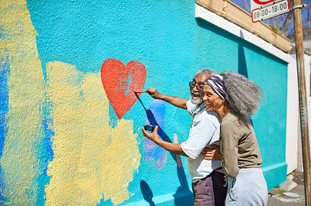 simsearch:859-06808649,k - Happy senior couple painting heart-shape mural on sunny wall Stock Photo - Premium Royalty-Free, Code: 6113-09240274