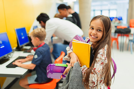simsearch:614-06895765,k - Portrait smiling, confident junior high girl student carrying books in library Stock Photo - Premium Royalty-Free, Code: 6113-09240288