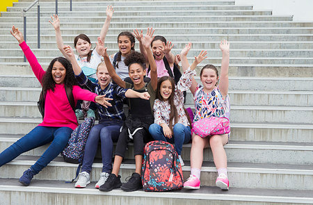 simsearch:649-06532718,k - Portrait enthusiastic junior high girl students waving on steps Stock Photo - Premium Royalty-Free, Code: 6113-09240294
