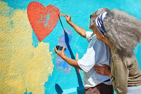 simsearch:859-06808650,k - Senior couple painting heart-shape mural on sunny wall Stock Photo - Premium Royalty-Free, Code: 6113-09240238